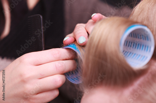 Female blond hair head curlers rollers hairdresser beauty salon