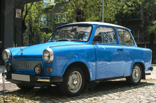 Blue vintage restored Trabant car on paved street