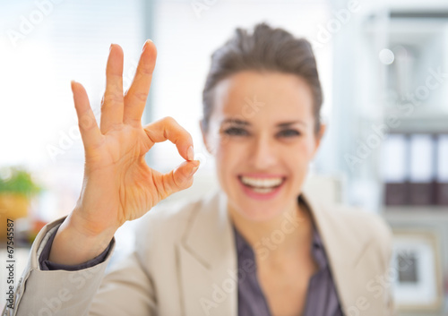 Closeup on happy business woman showing ok gesture