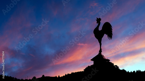 Spectacular dawn with cockerel weathervane and landscape.