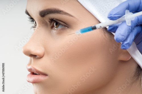 young Caucasian woman getting cosmetic injection