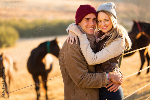 happy young couple in horse ranch