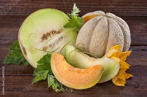 Fresh domestic cantaloupe melon on a wooden background