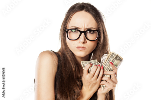 stingy beautiful woman holding her money