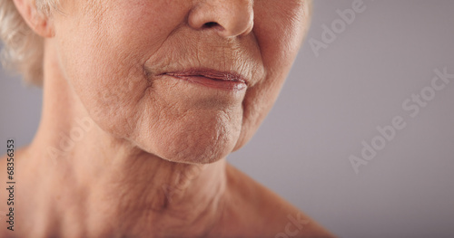 Senior female face with wrinkled skin