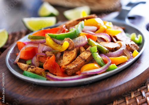 mexican chicken fajitas in iron skillet with peppers