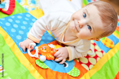 Infant boy on playmat