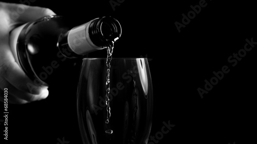 Man pouring white wine into a glass