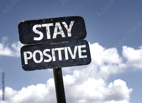 Stay Positive sign with clouds and sky background