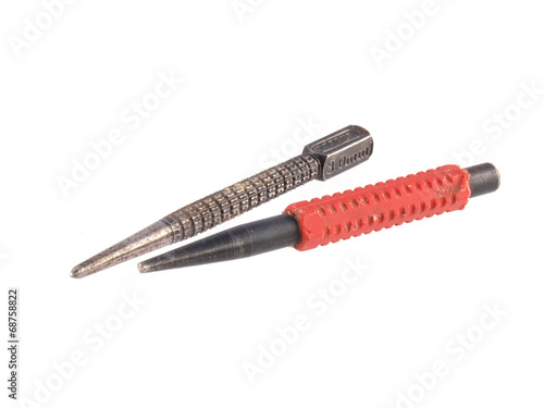 Close up photo of two nail punches on a white background.