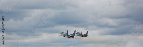 Two MiG 29 with camouflage against clear sky