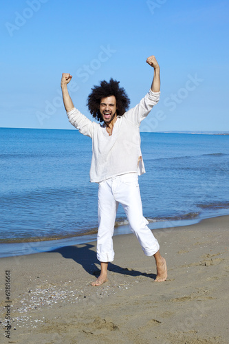 Happy successful man smiling in front of the sea
