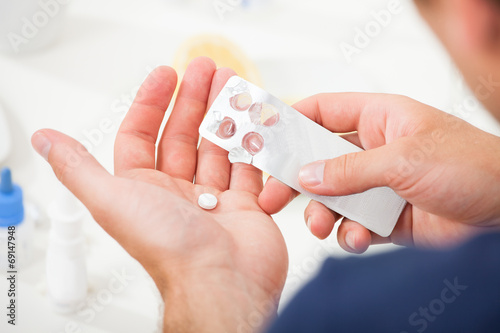 Man Taking Pill Out From Blister Pack