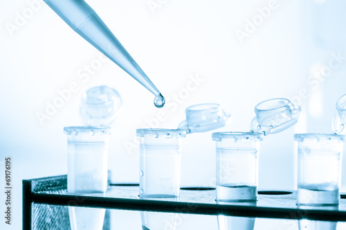 pipette and test tube on blue background