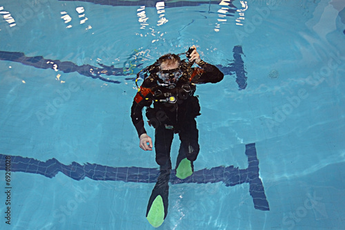 man teaches diving in the pool, swim coach