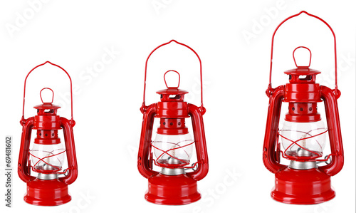 Evolution concept.Red kerosene lamps isolated on white