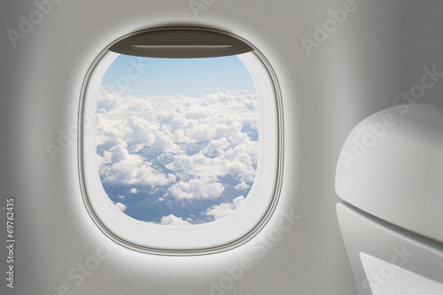 Aeroplane or jet interior with window and chair as traveling con