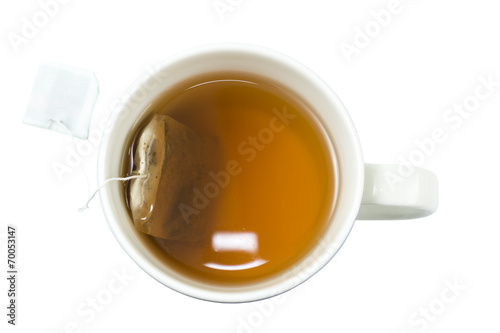Closeup of a cup of tea and teabag viewed from above, isolated