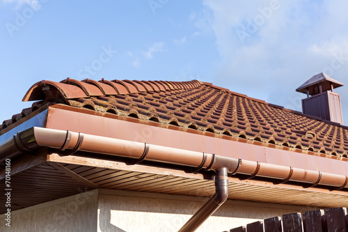 Red tiled roof with gutter and chimney