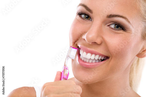 Woman brushing teeth holding toothbrush