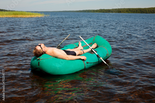 Man resting in a rubber boat