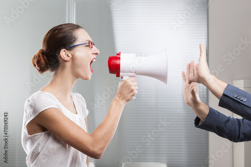 Businesswoman shouting in megaphone