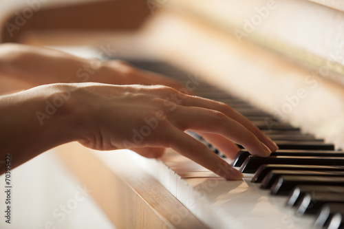 woman hands playing piano