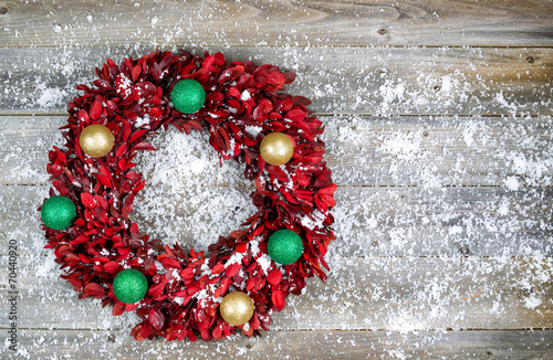 Natural leaf wreath with ornaments and snow for the seasonal hol