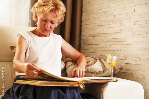 Senior woman watching a photo album