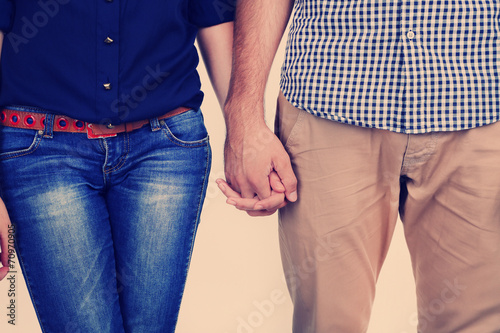 Young couple holding hands, close-up