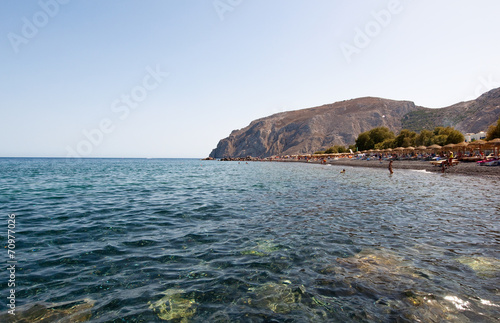 Tourists sunbathe on the Kamari Beach. Santorini(Thira), Greece.