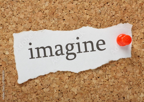 The word imagine on a cork notice board