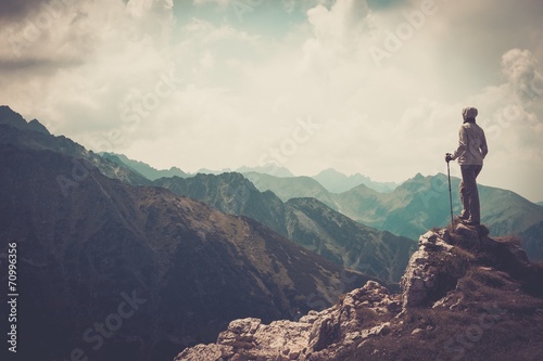 Woman hiker on a top of a mountain