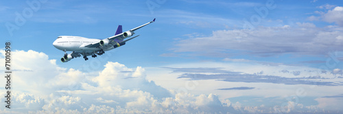 Jet plane in a blue cloudy sky