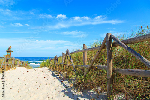 Entrance to the beach with white sand