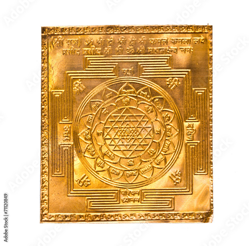 Golden yantra on white.Manufactured from copper plate