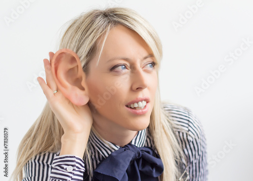 Woman listening with ridiculously big ear