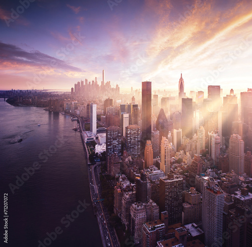 New York City - colorful sunset over manhattan with sunbeams