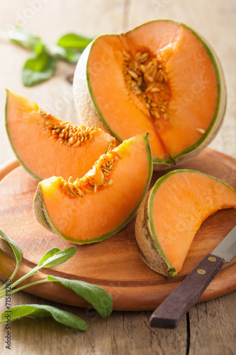 cantaloupe melon sliced on wooden background