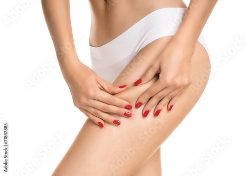 Female squeezing buttock and showing no cellulite