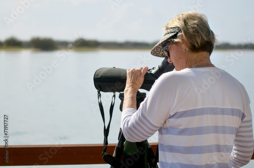 Mature woman birdwatching