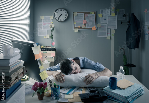 Businessman sleeping in the office overnight