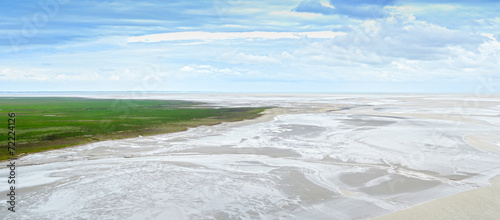 Low tide in Mont Saint Michel Bay. Panorama in Normandy, France.