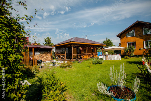 Cozy wooden house in the coniferous forest