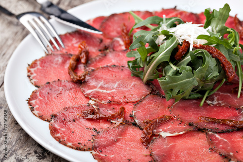 white dish with carpaccio of beef