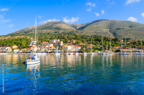 Yacht on sea and view of Agia Efimia fishing village, Kefalonia