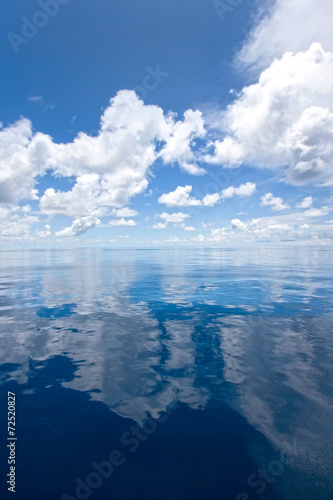 Still seas with perfect reflections of the clouds.