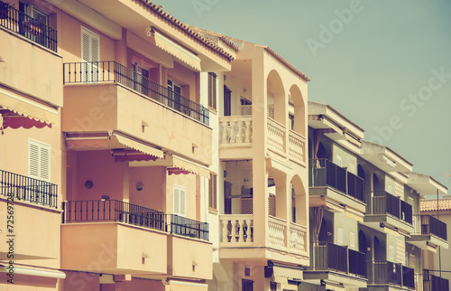 Portrait of tropical apartment building. Vintage effect.