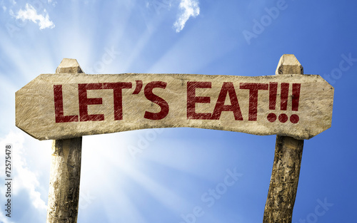 Let's Eat!! wooden sign on a summer day