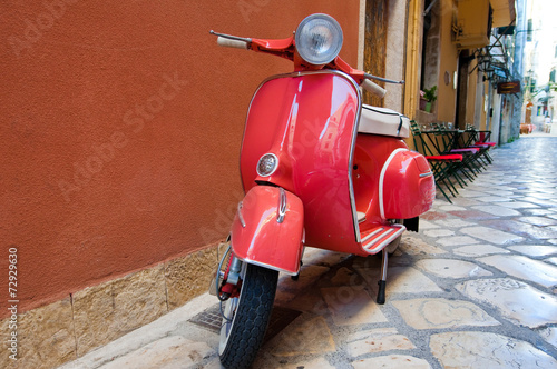 Classic Vespa scooter on Kerkyra street. Corfu island. Greece.